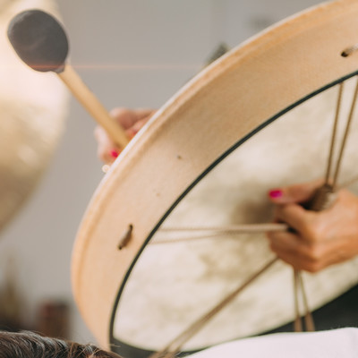 Drummer leading a sound healing circle at The Well House in Towson, MD, using rhythmic drumming to enhance relaxation and foster a deep sense of connection among participants.