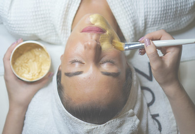 Skincare specialist at The Well House in Towson, MD, providing a rejuvenating facial treatment that promotes relaxation and enhances the client's natural glow.